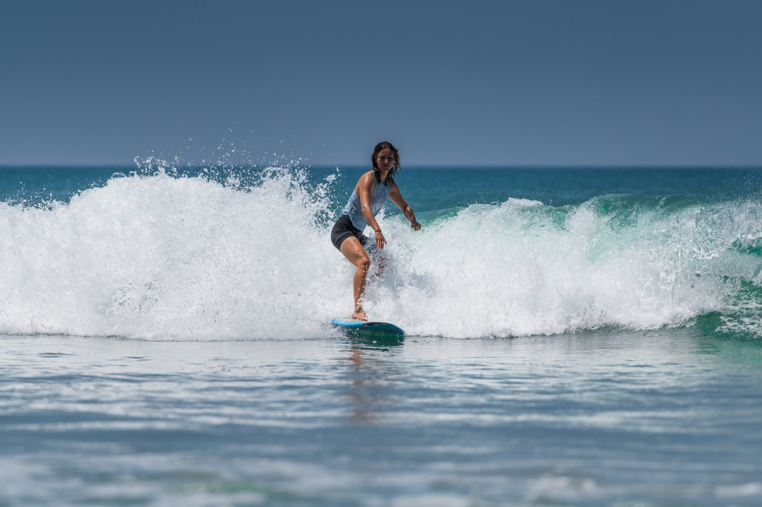 VARKALA, INDIA - Mar 14, 2020: A female Surfer  surfing in the waves in Kerala